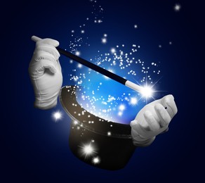 Magician showing trick with magic wand and top hat on dark blue background