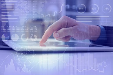 Image of Technology and business. Woman working on tablet computer at table and graphs, double exposure