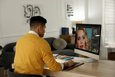 Photo of Professional retoucher working on computer in office