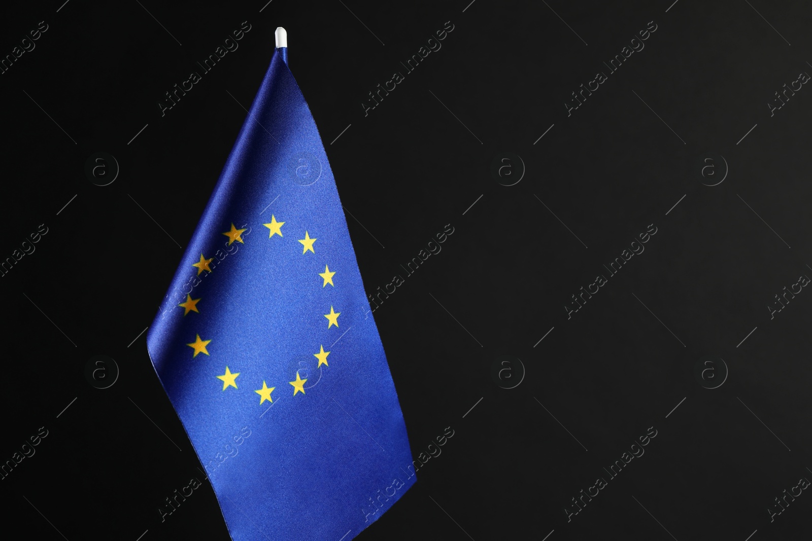 Photo of One flag of European Union on black background. Space for text