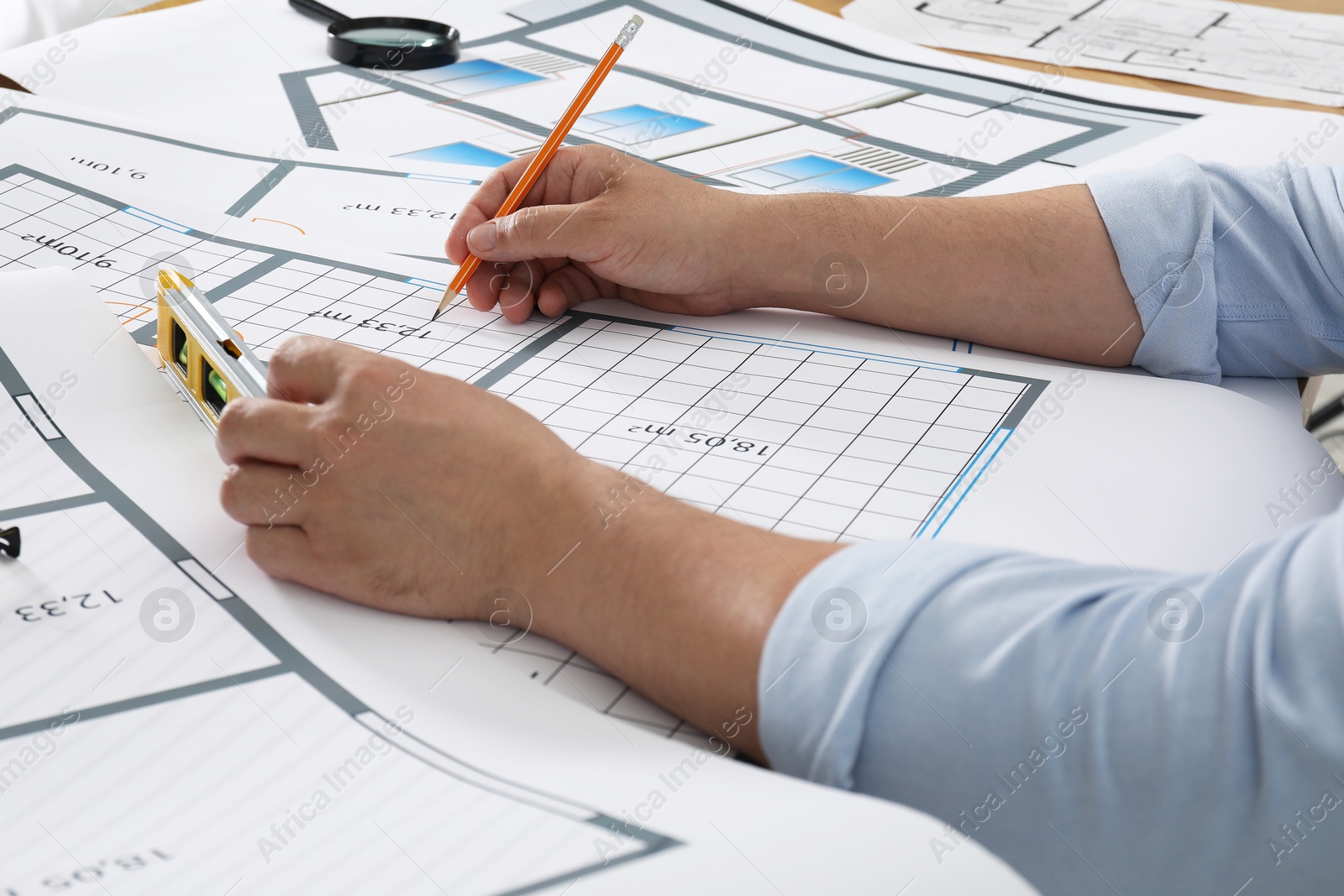 Photo of Architect working with project at table in office, closeup