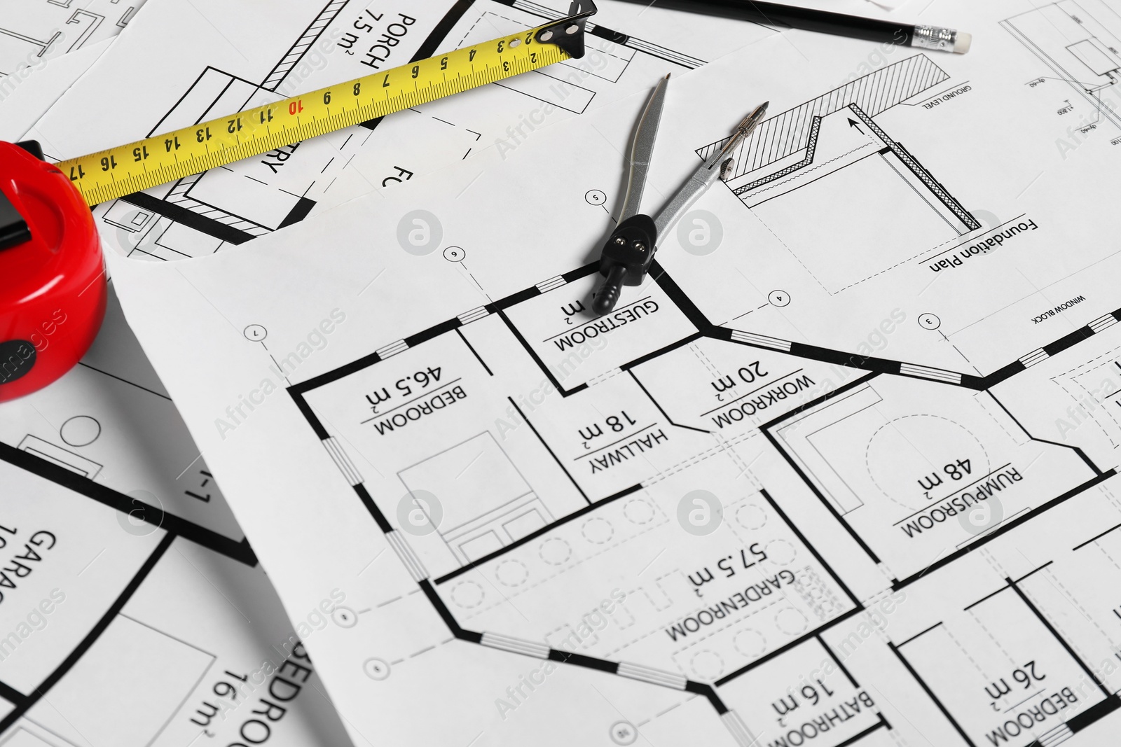 Photo of Different engineering drawings and tools on table