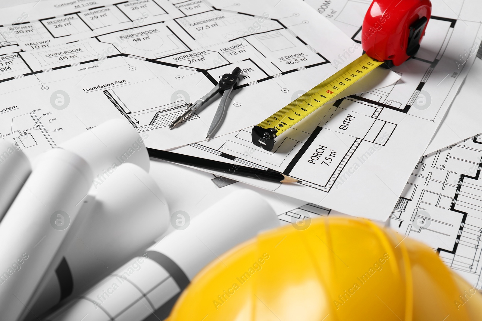 Photo of Different engineering drawings and tools on table, closeup