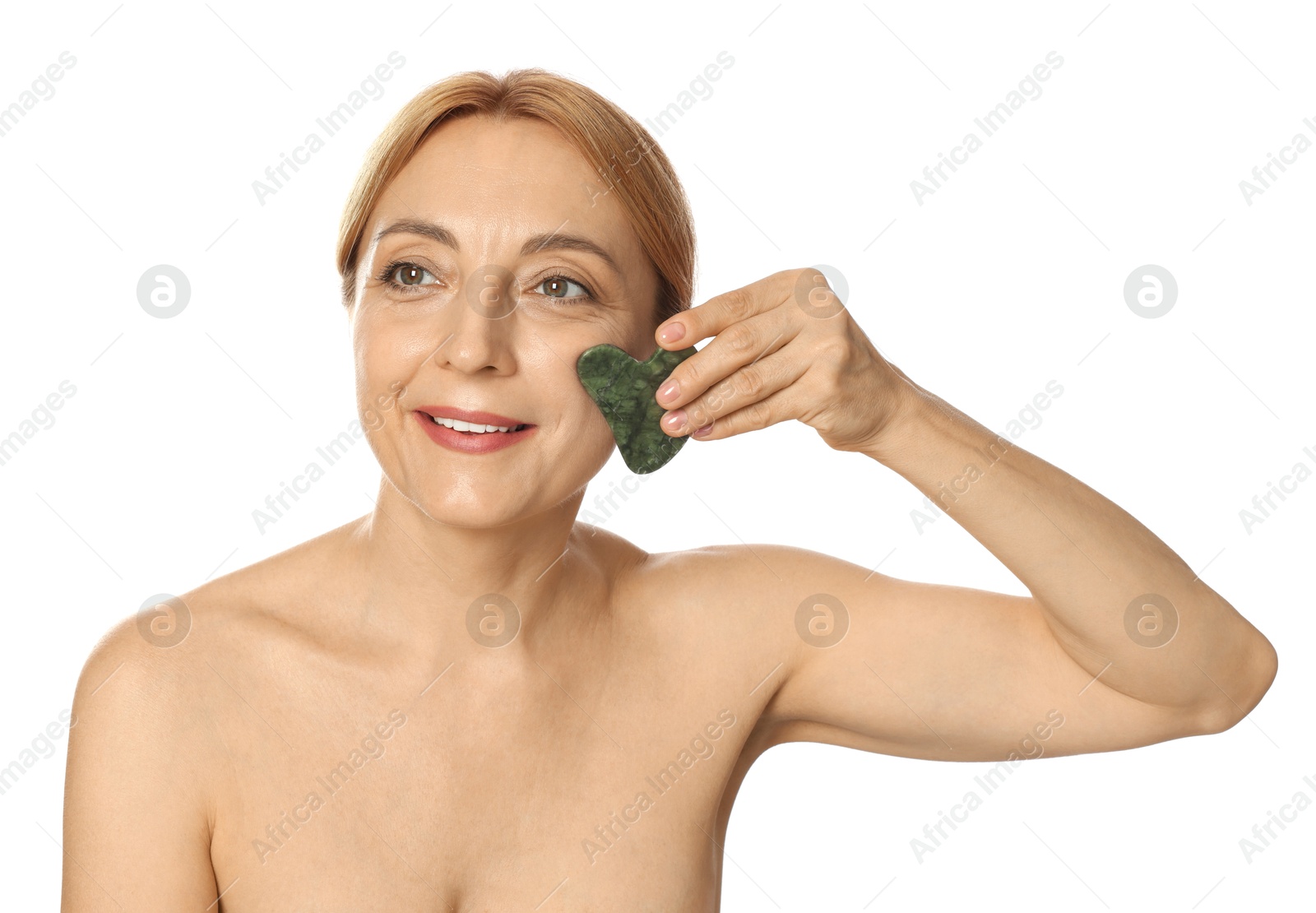 Photo of Smiling woman doing facial self massage with gua sha tool on white background