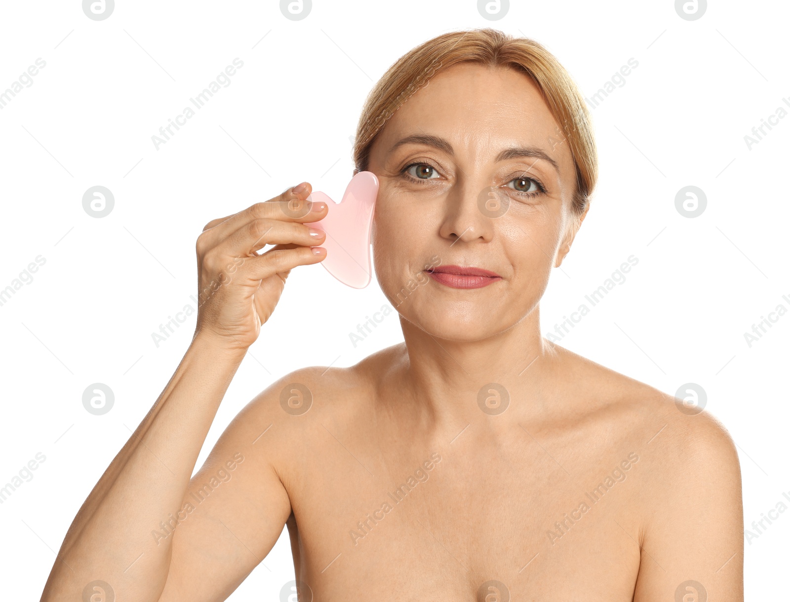 Photo of Beautiful woman doing facial self massage with gua sha tool on white background