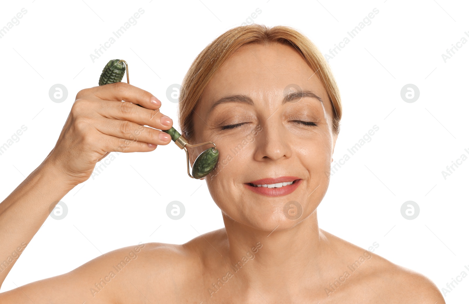 Photo of Smiling woman doing facial self massage with roller on white background