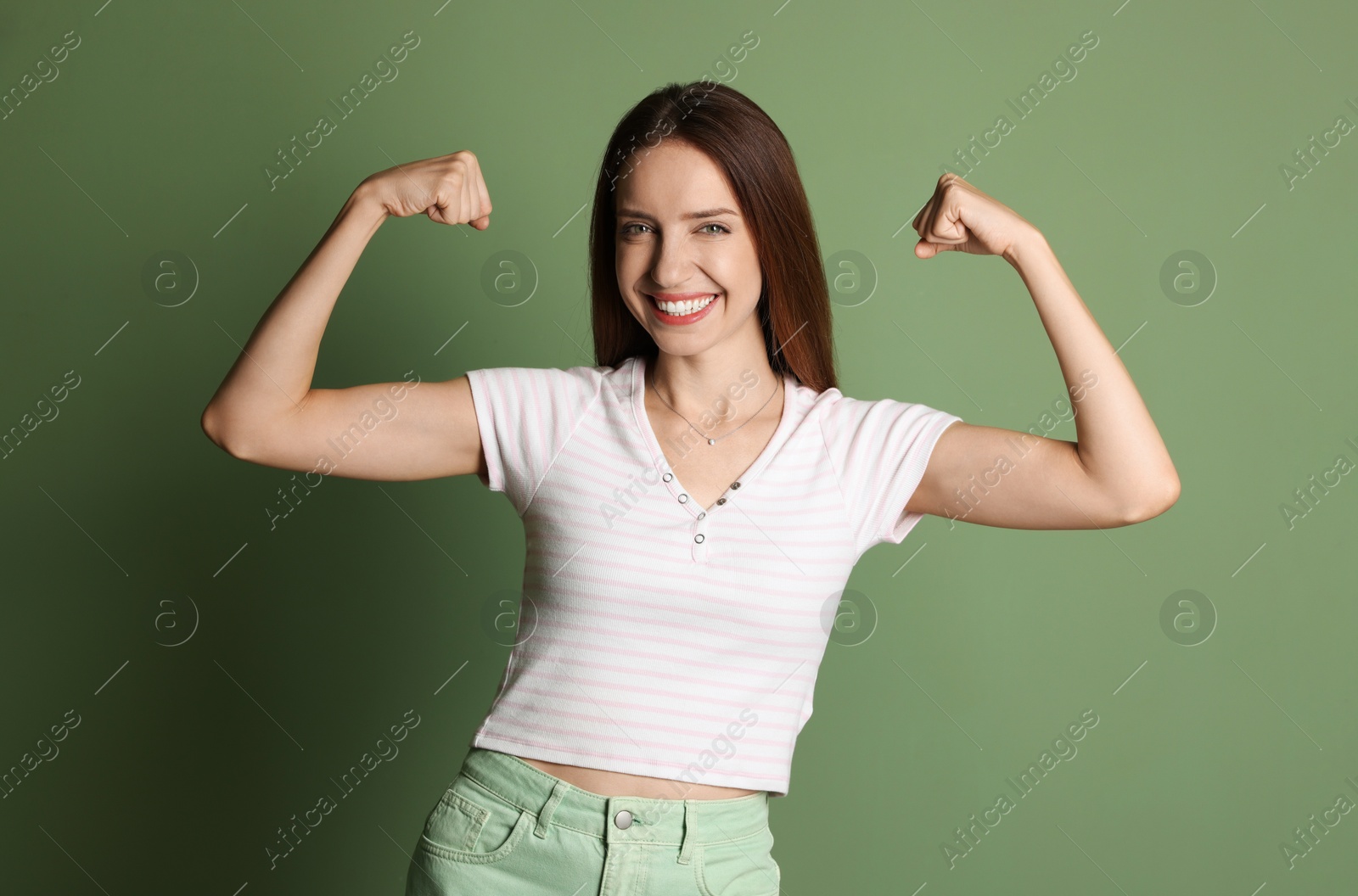 Photo of Portrait of happy winner on green background