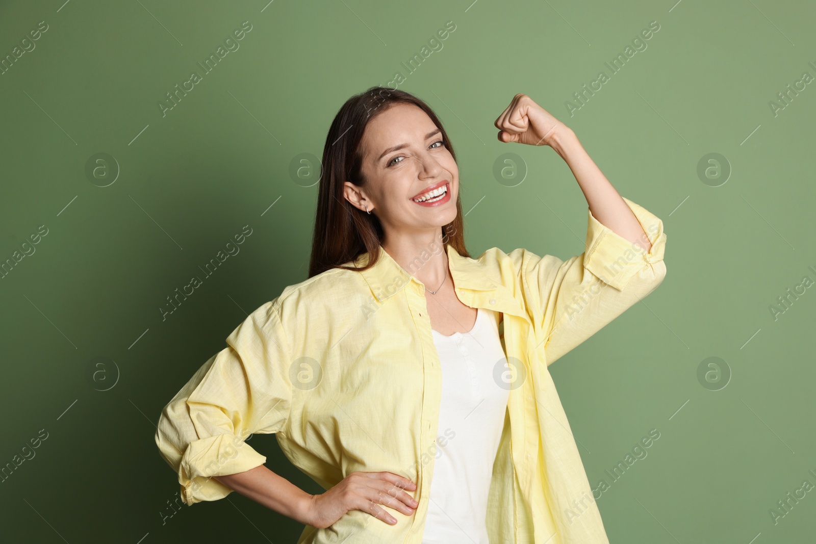 Photo of Portrait of happy winner on green background