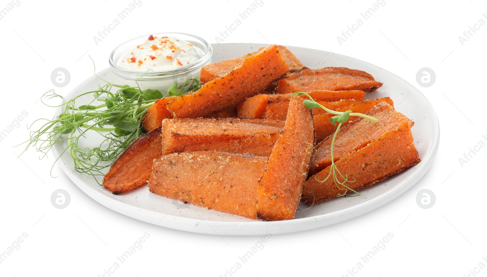 Photo of Pieces of tasty baked sweet potato with sauce and microgreens isolated on white