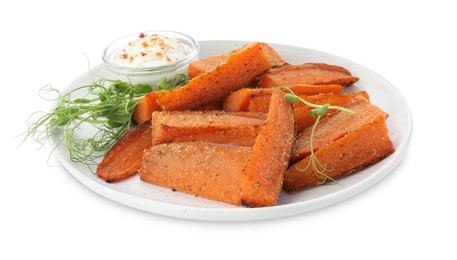 Photo of Pieces of tasty baked sweet potato with sauce and microgreens isolated on white