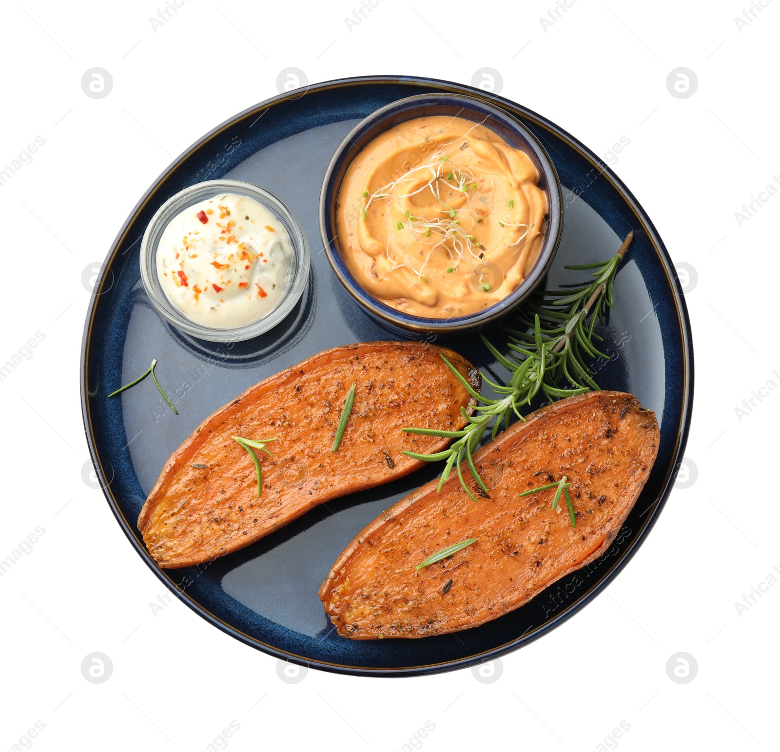 Photo of Halves of tasty baked sweet potato served with sauces isolated on white, top view