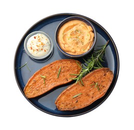 Photo of Halves of tasty baked sweet potato served with sauces isolated on white, top view