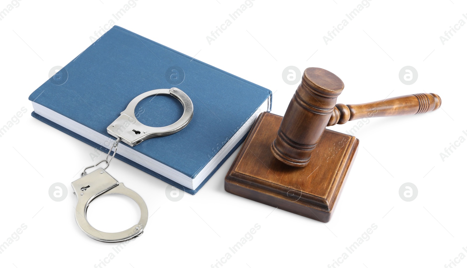 Photo of Handcuffs, judge's gavel and book isolated on white