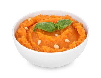 Photo of Tasty mashed sweet potato with basil and seeds in bowl isolated on white