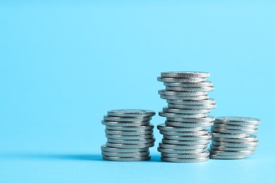 Photo of Salary concept. Stacked coins on light blue background, space for text