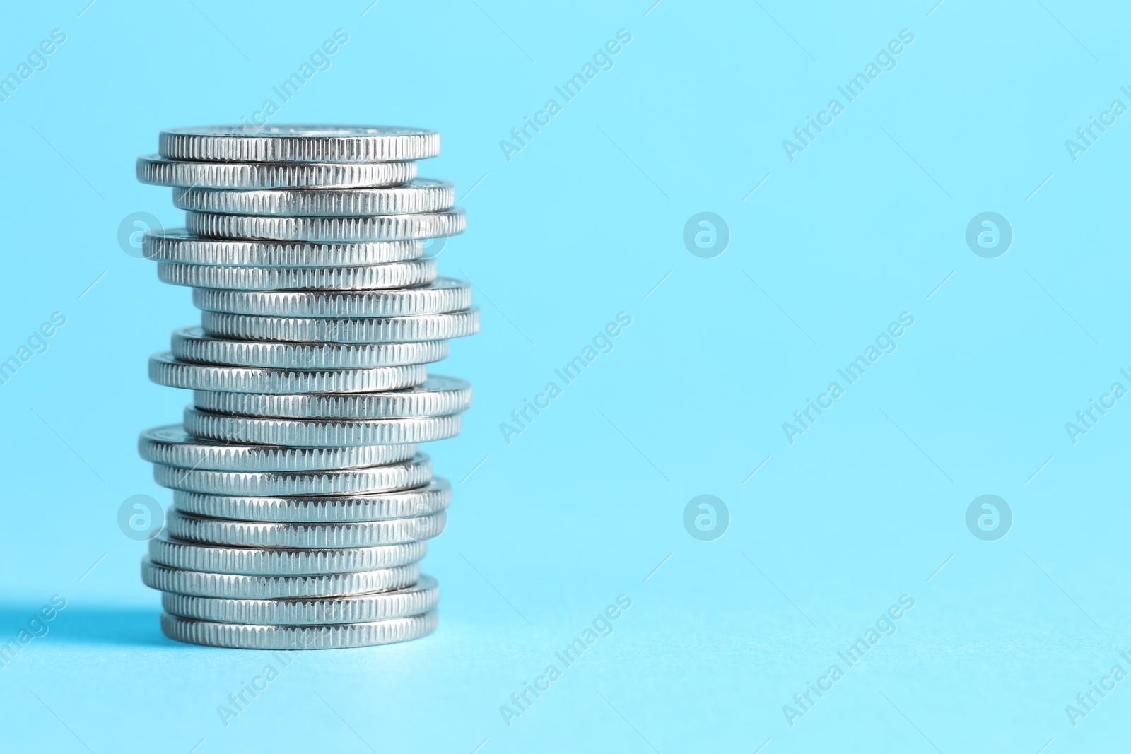 Photo of Salary concept. Stacked coins on light blue background, space for text