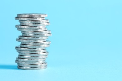 Photo of Salary concept. Stacked coins on light blue background, space for text