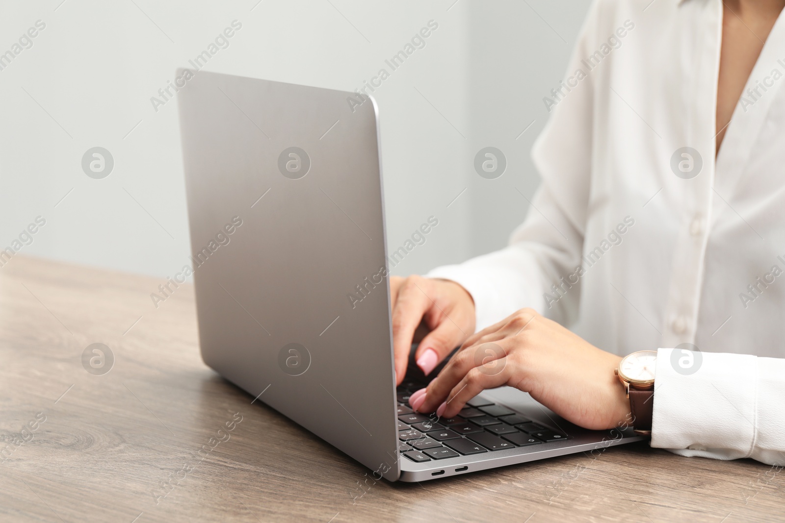 Photo of House hunting. Woman with laptop at wooden table, closeup