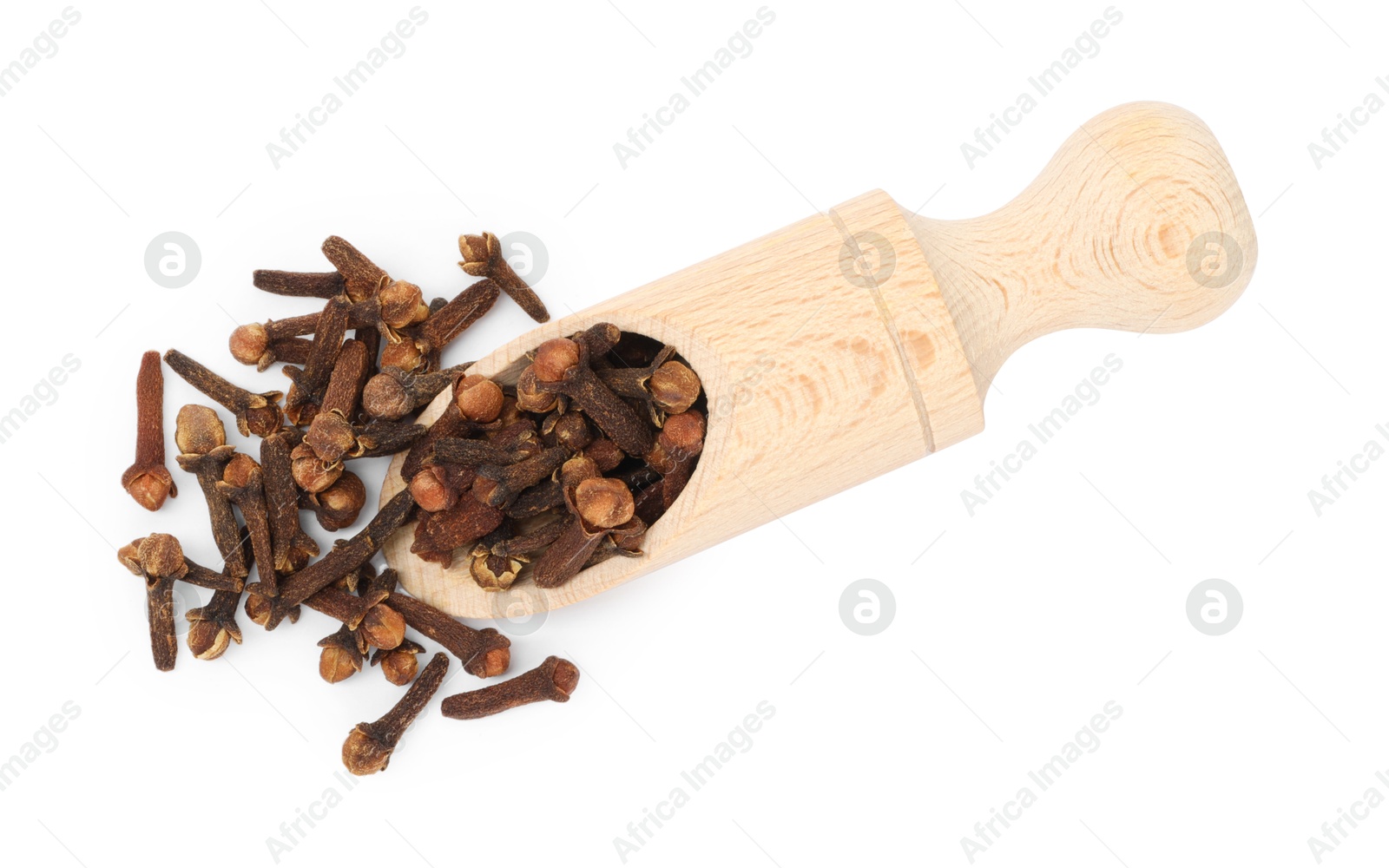 Photo of Dry clove buds in wooden scoop on white background, top view. Aromatic spice