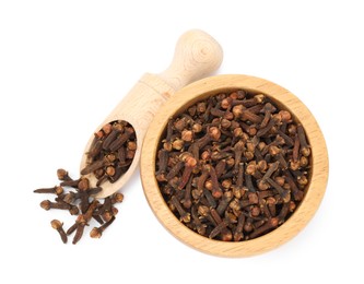 Dry clove buds in wooden scoop and bowl on white background, top view. Aromatic spice