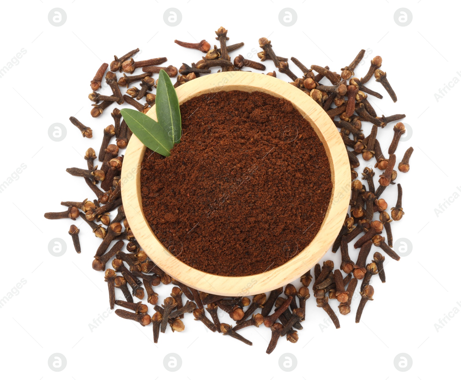 Photo of Clove powder in wooden bowl and dried buds on white background, top view. Aromatic spice