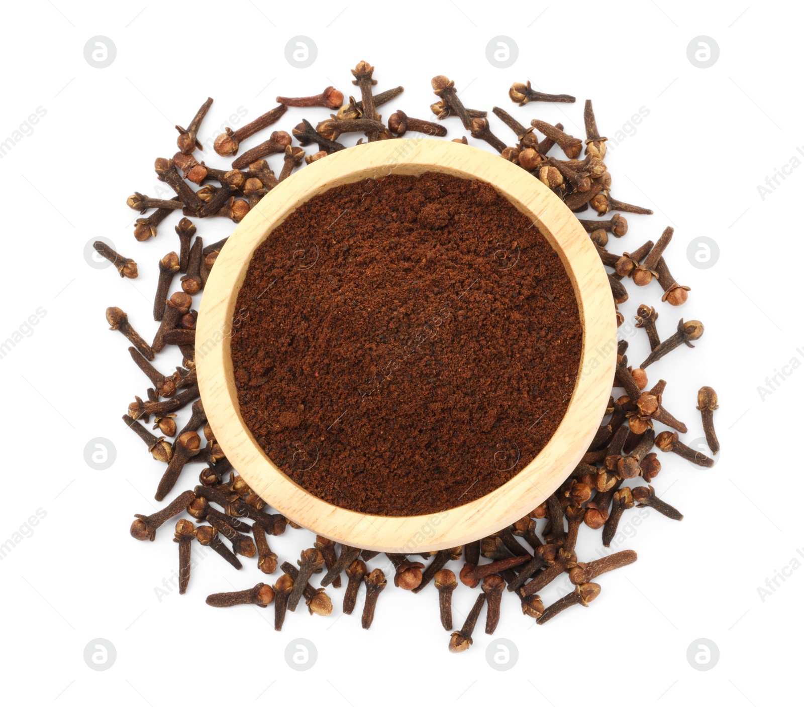 Photo of Clove powder in wooden bowl and dried buds on white background, top view. Aromatic spice