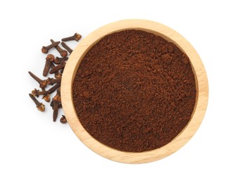 Photo of Clove powder in wooden bowl and dried buds on white background, top view. Aromatic spice