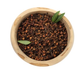 Photo of Dry clove buds and green leaves in wooden bowl on white background, top view. Aromatic spice