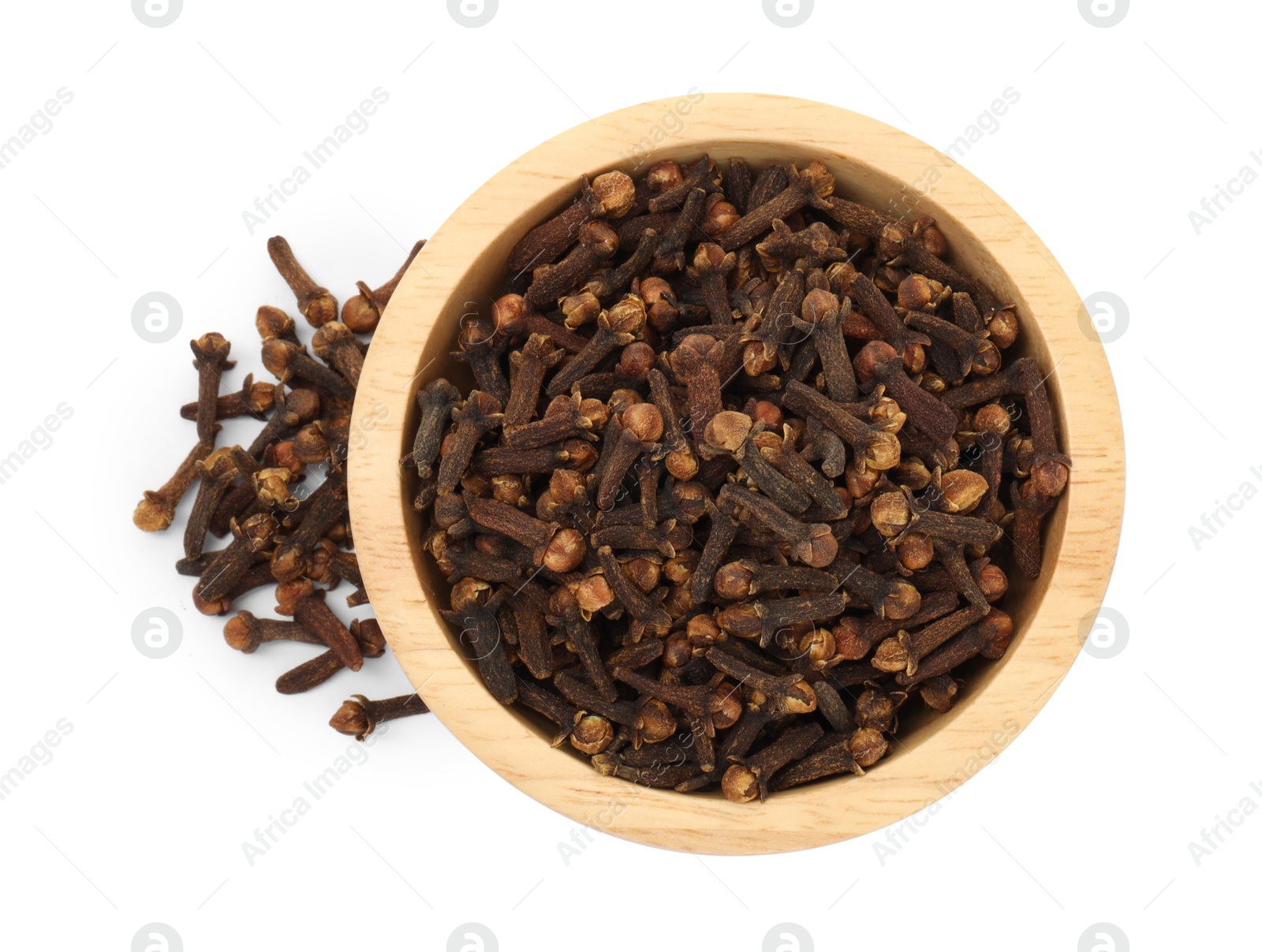 Photo of Dry clove buds in wooden bowl on white background, top view. Aromatic spice