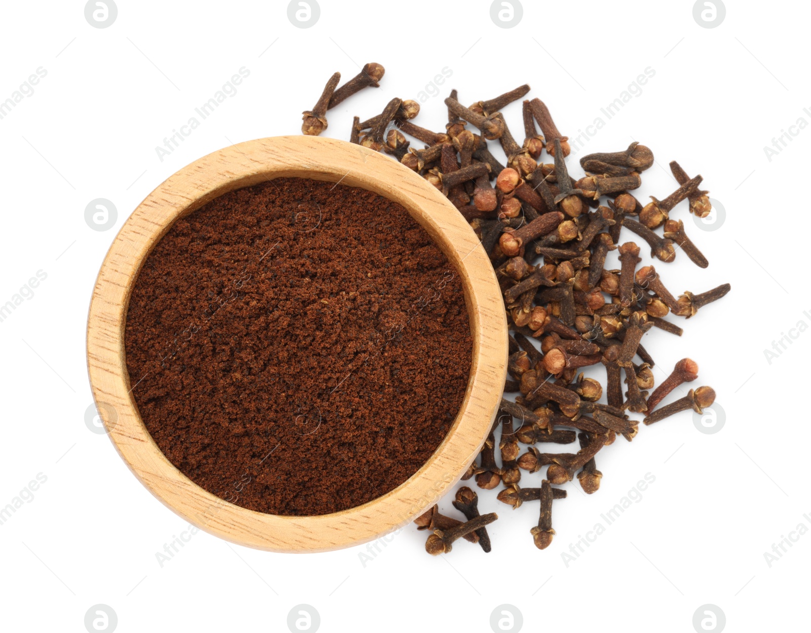 Photo of Clove powder in wooden bowl and dried buds on white background, top view. Aromatic spice