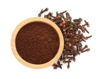 Photo of Clove powder in wooden bowl and dried buds on white background, top view. Aromatic spice