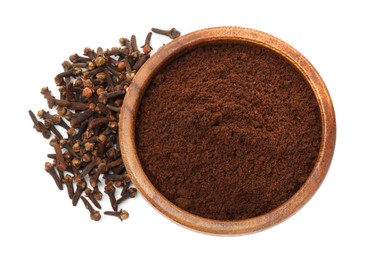 Photo of Clove powder in wooden bowl and dried buds on white background, top view. Aromatic spice