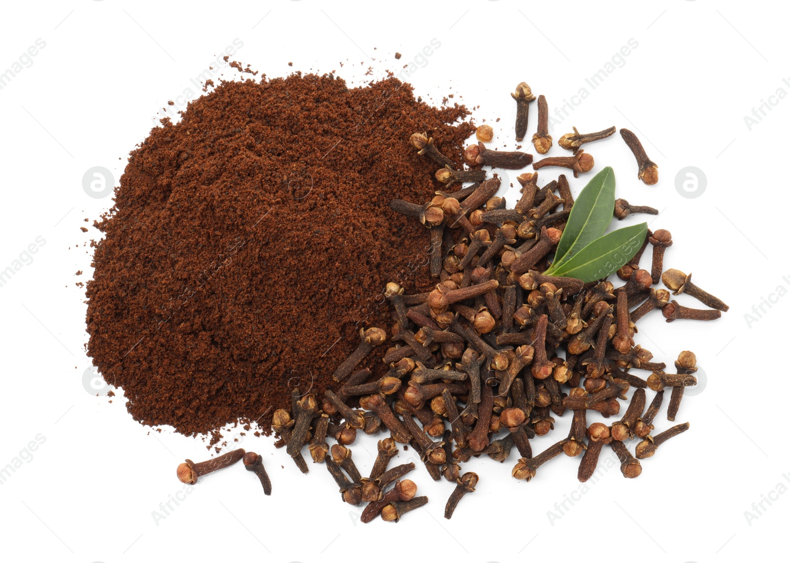 Photo of Pile of clove powder, dried buds and green leaves on white background, top view. Aromatic spice