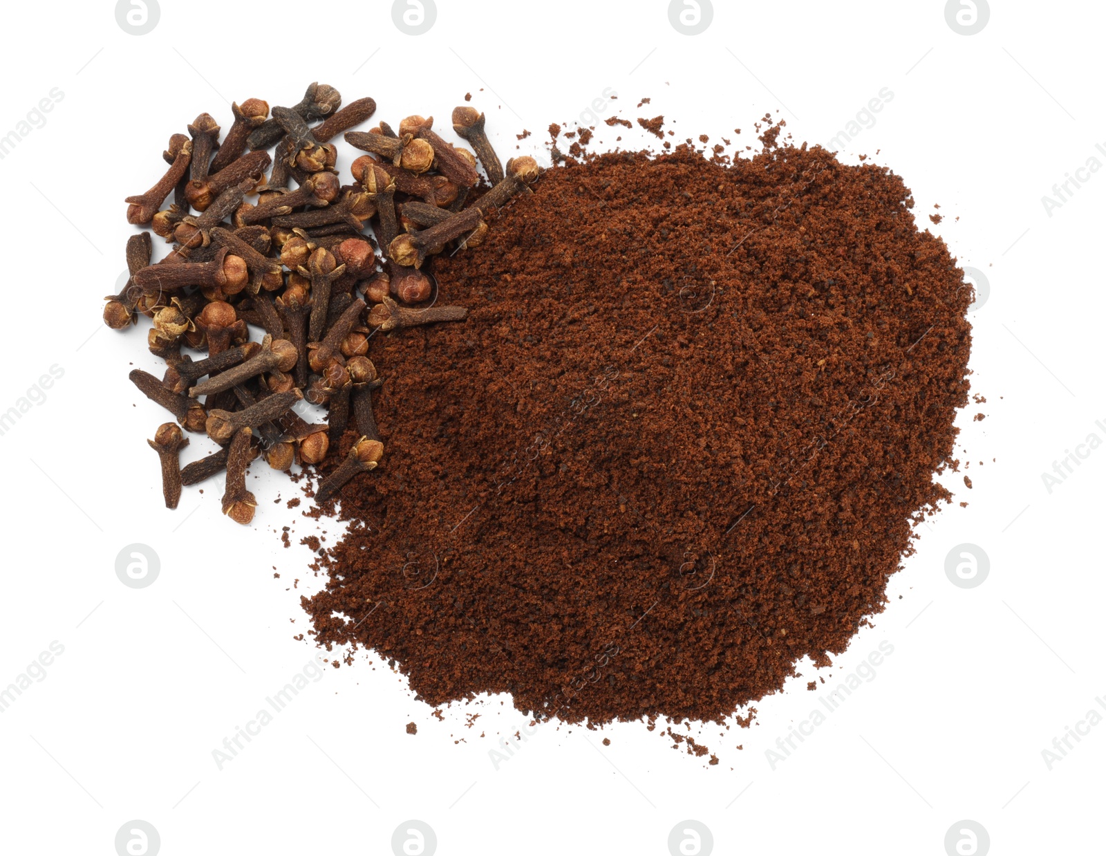 Photo of Pile of clove powder and dried buds on white background, top view. Aromatic spice