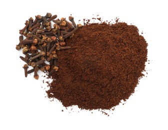 Photo of Pile of clove powder and dried buds on white background, top view. Aromatic spice