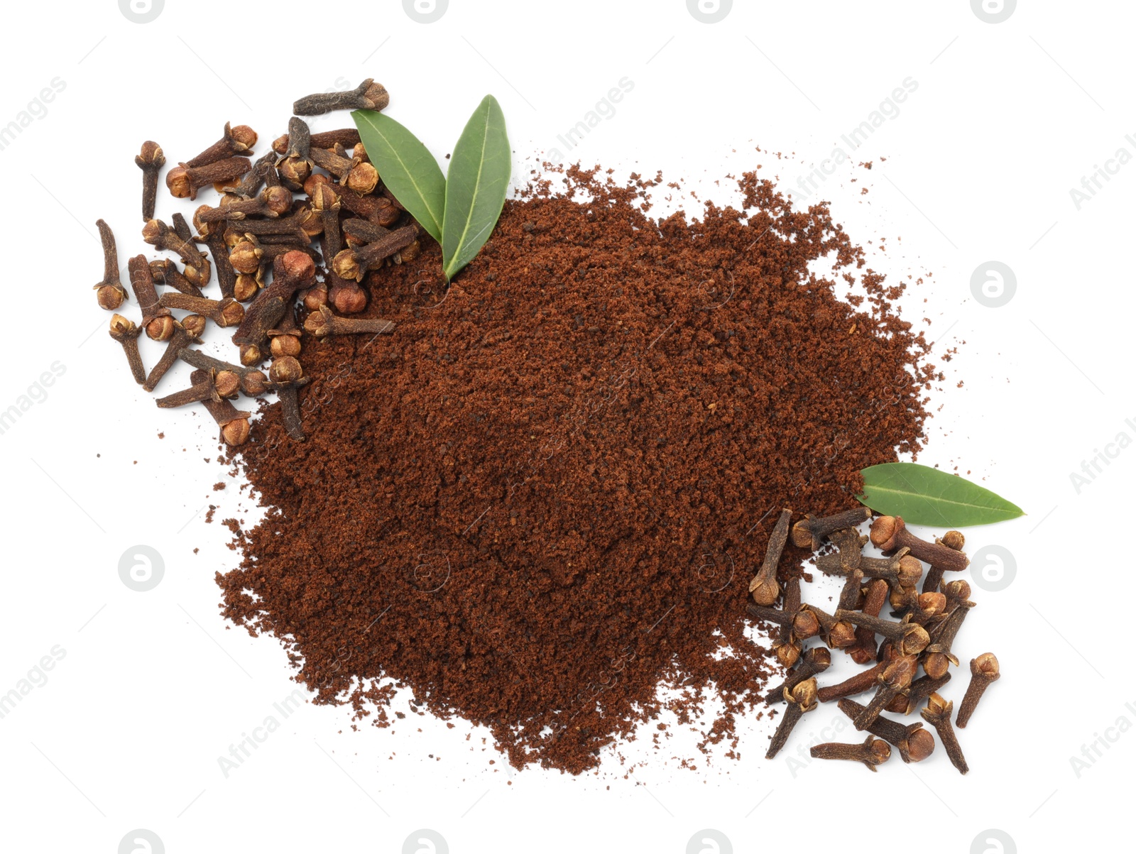 Photo of Pile of clove powder, dried buds and green leaves on white background, top view. Aromatic spice