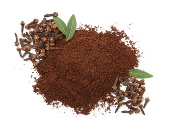 Pile of clove powder, dried buds and green leaves on white background, top view. Aromatic spice