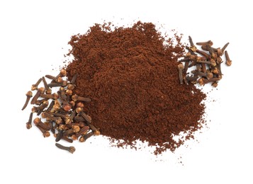 Photo of Pile of clove powder and dried buds on white background, top view. Aromatic spice