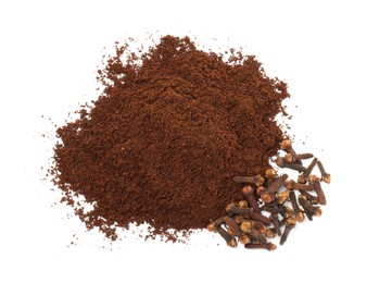 Photo of Pile of clove powder and dried buds on white background, top view. Aromatic spice