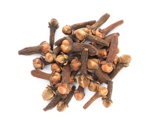 Photo of Pile of dry clove buds on white background, top view. Aromatic spice