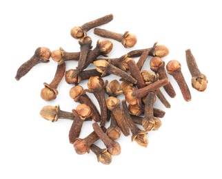 Photo of Pile of dry clove buds on white background, top view. Aromatic spice