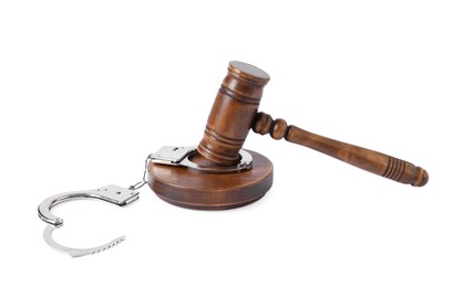 Photo of Handcuffs and judge's gavel isolated on white