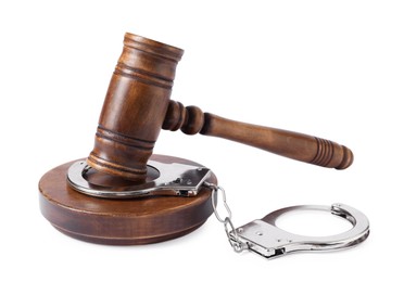 Handcuffs and judge's gavel isolated on white