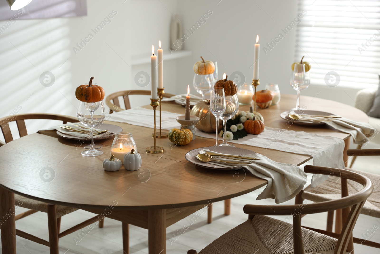 Photo of Stylish dining room with beautiful table setting and autumn decor