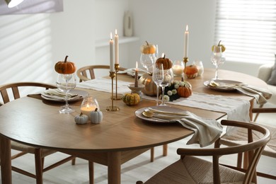 Photo of Stylish dining room with beautiful table setting and autumn decor