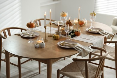 Stylish dining room with beautiful table setting and autumn decor