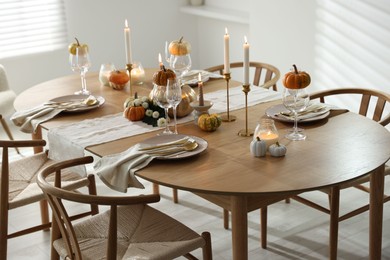 Photo of Stylish dining room with beautiful table setting and autumn decor