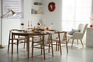 Photo of Stylish dining room with beautiful table setting and autumn decor