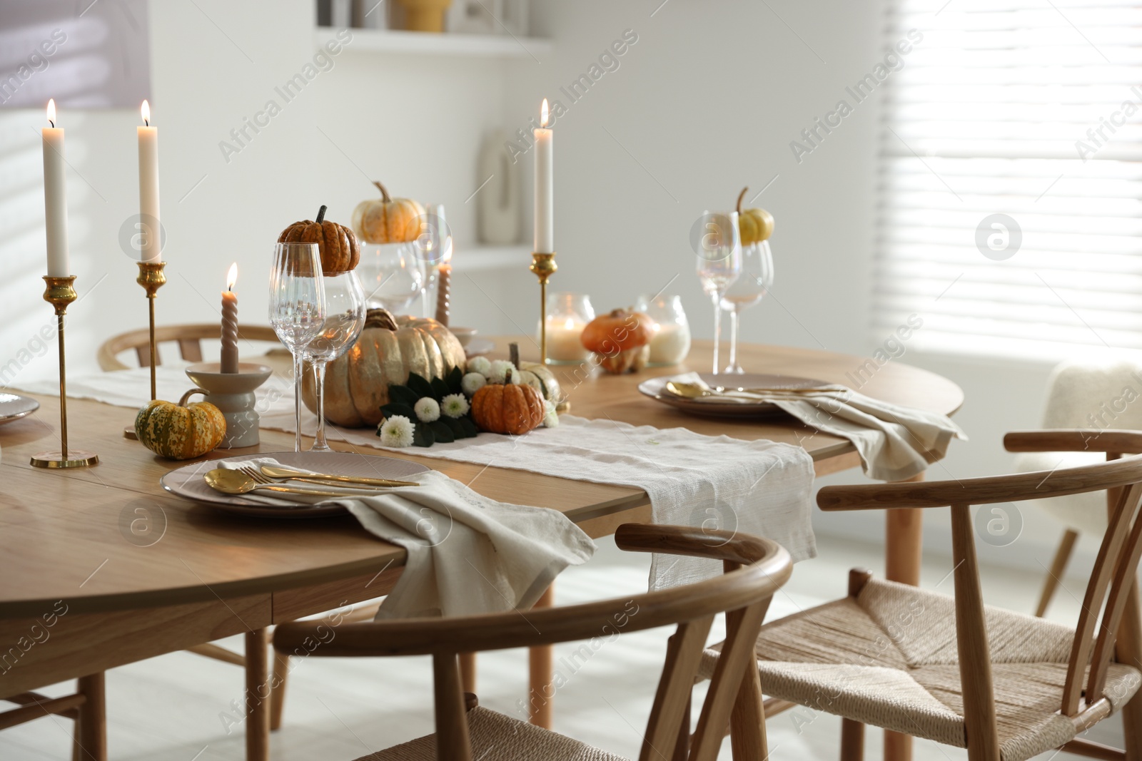 Photo of Stylish dining room with beautiful table setting and autumn decor