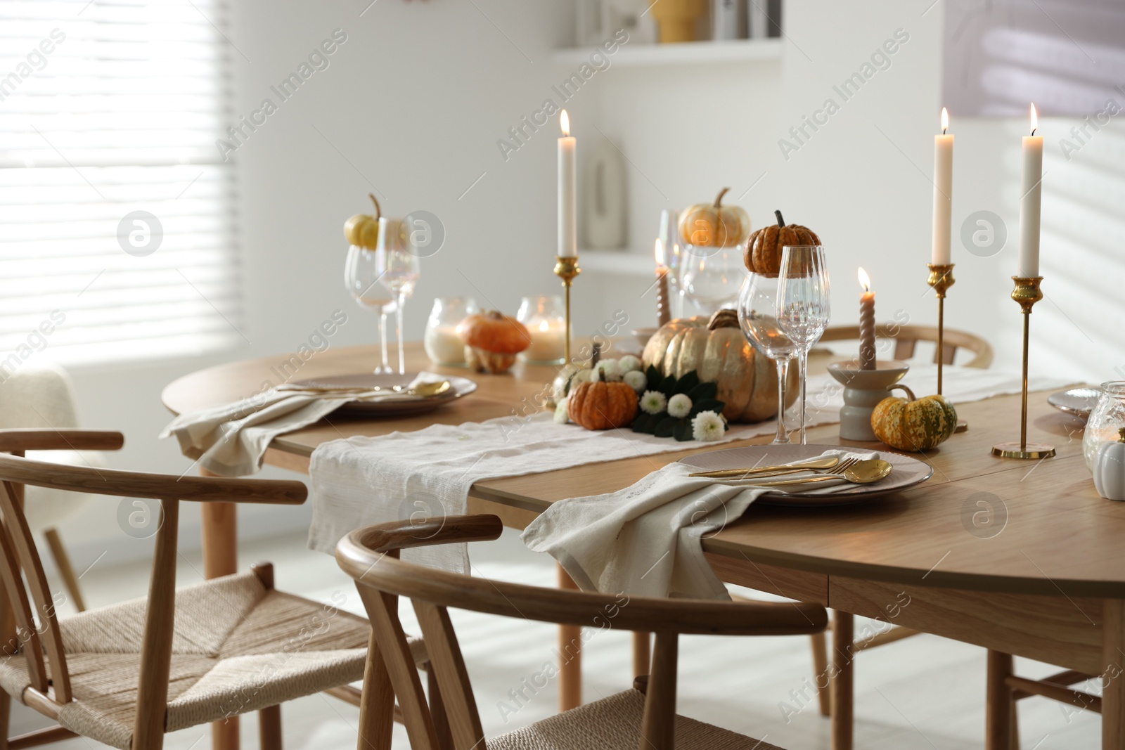 Photo of Stylish dining room with beautiful table setting and autumn decor